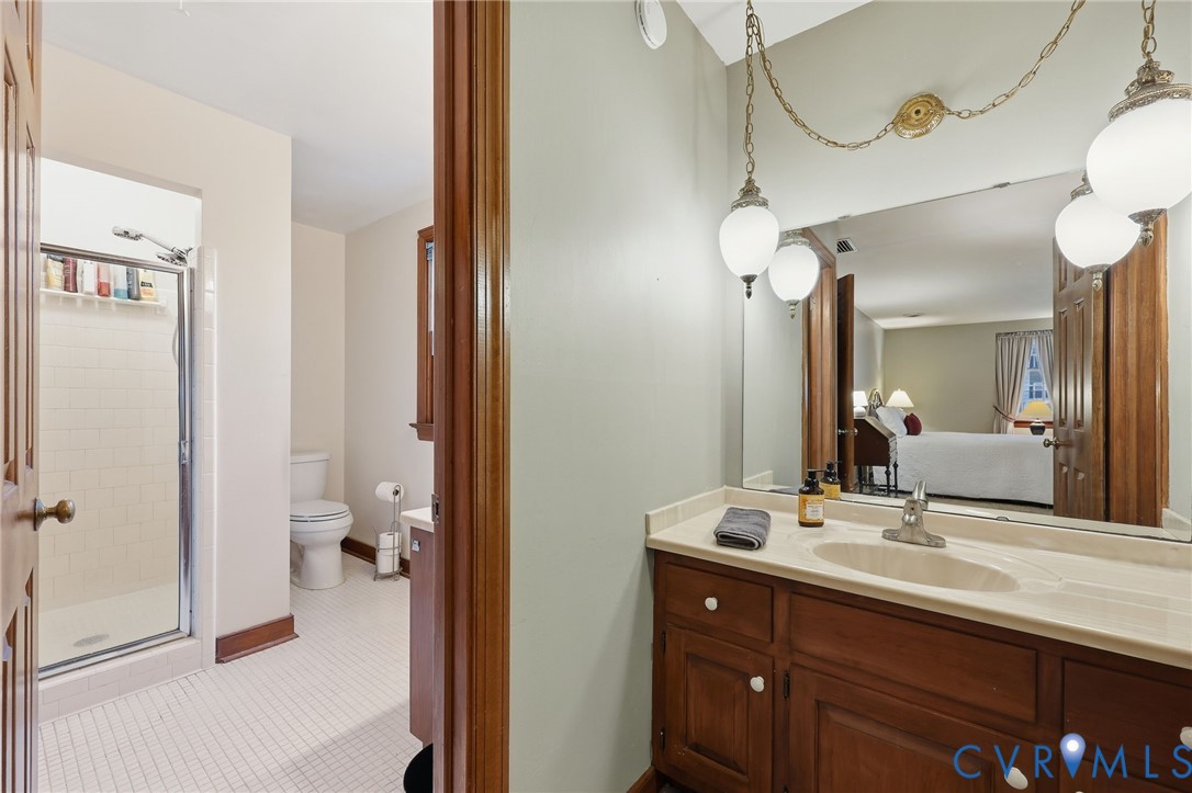 8216 Chainmaile Road North Chesterfield, VA 23235 - Photo 20 of 36 a en suite bathroom with a double vanity sink a mirror and a shower