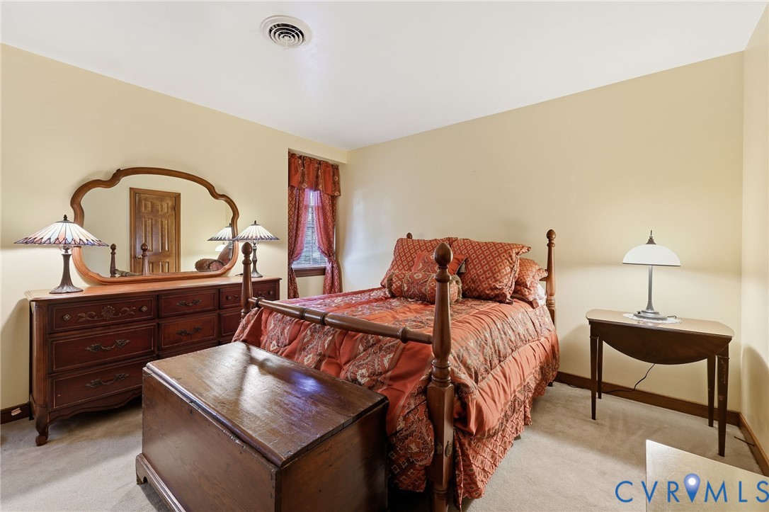 8216 Chainmaile Road North Chesterfield, VA 23235 - Photo 22 of 36 a bed room with a bed and a dresser