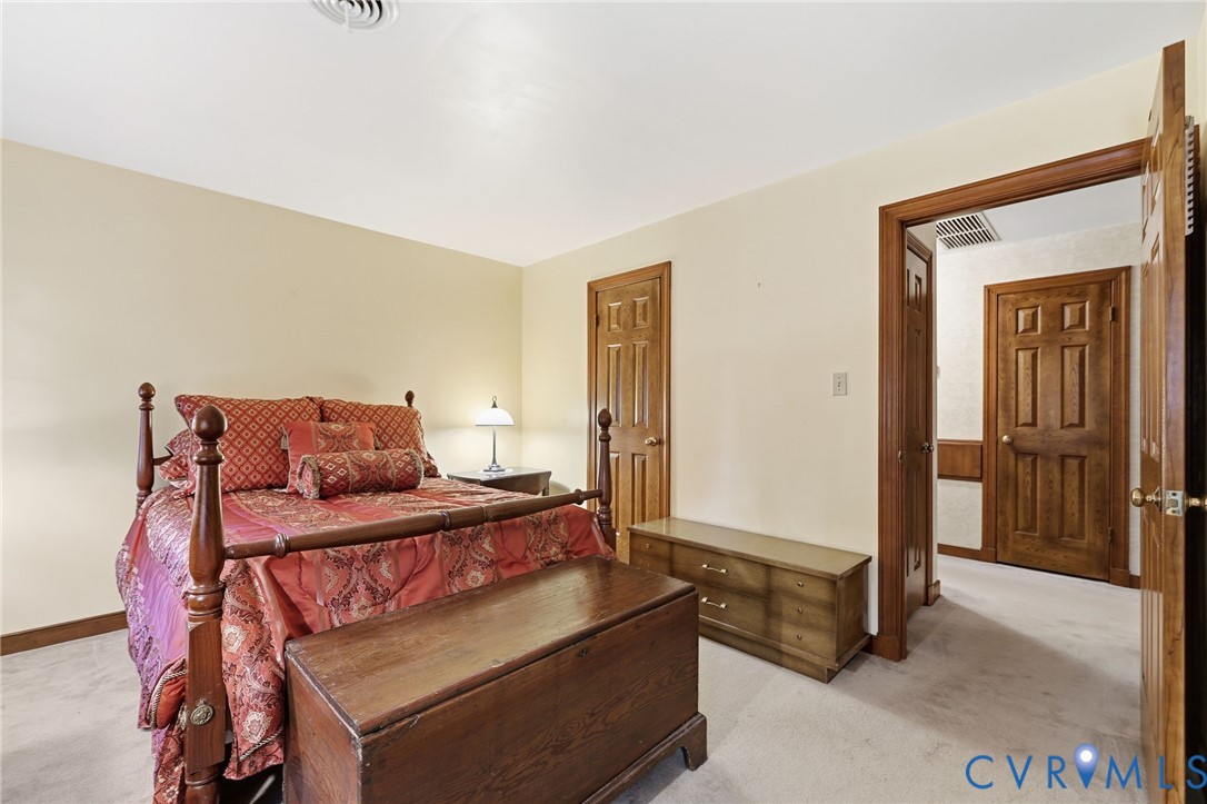 8216 Chainmaile Road North Chesterfield, VA 23235 - Photo 23 of 36 a bed room with a bed and mirror