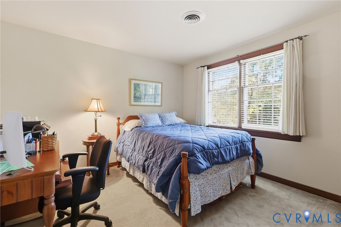 8216 Chainmaile Road North Chesterfield, VA 23235 - Photo 26 of 36 a spacious bedroom with a bed a chair and a large window