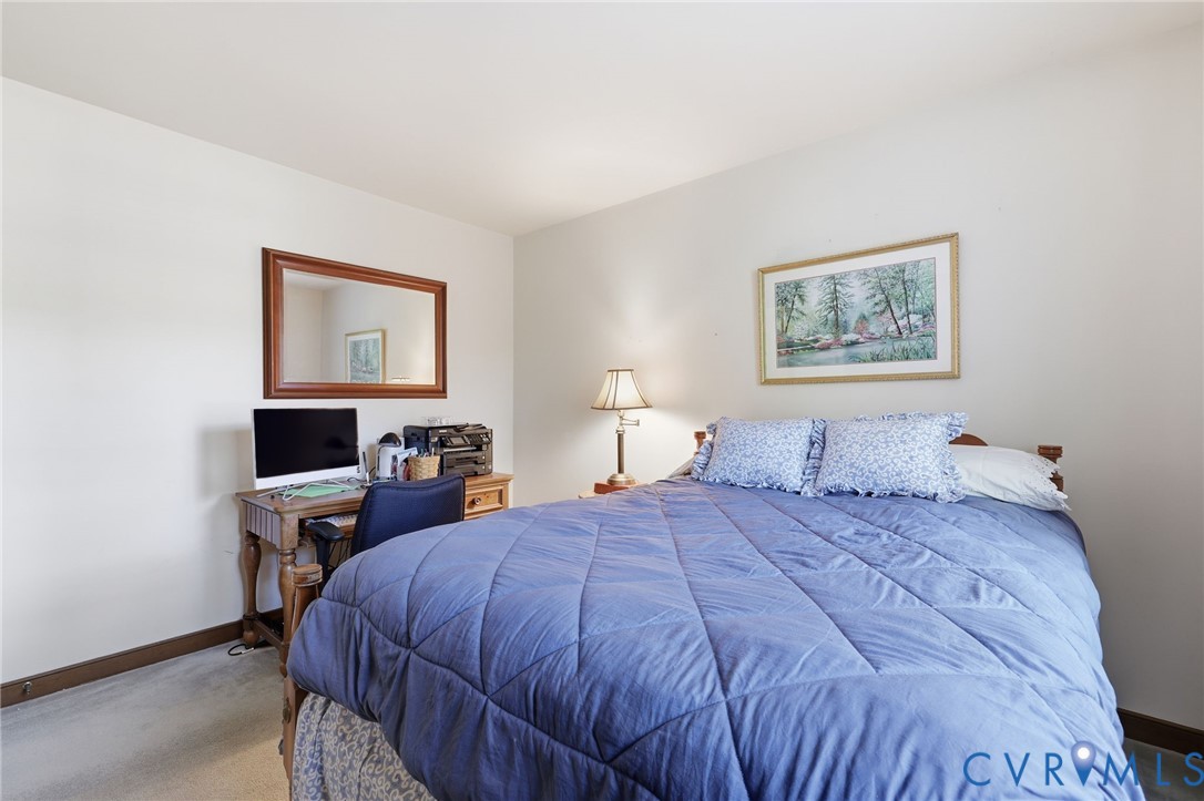 8216 Chainmaile Road North Chesterfield, VA 23235 - Photo 27 of 36 a bedroom with a large bed and a tv