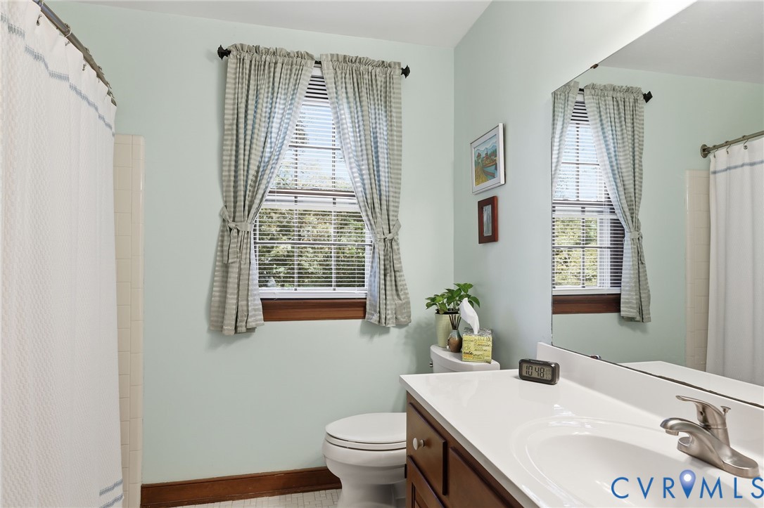 8216 Chainmaile Road North Chesterfield, VA 23235 - Photo 28 of 36 a bathroom with a granite countertop sink a toilet and a window