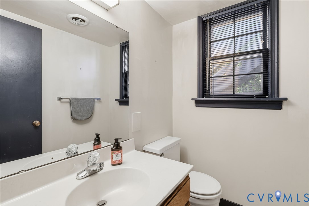8216 Chainmaile Road North Chesterfield, VA 23235 - Photo 30 of 36 a bathroom with a sink a toilet and mirror