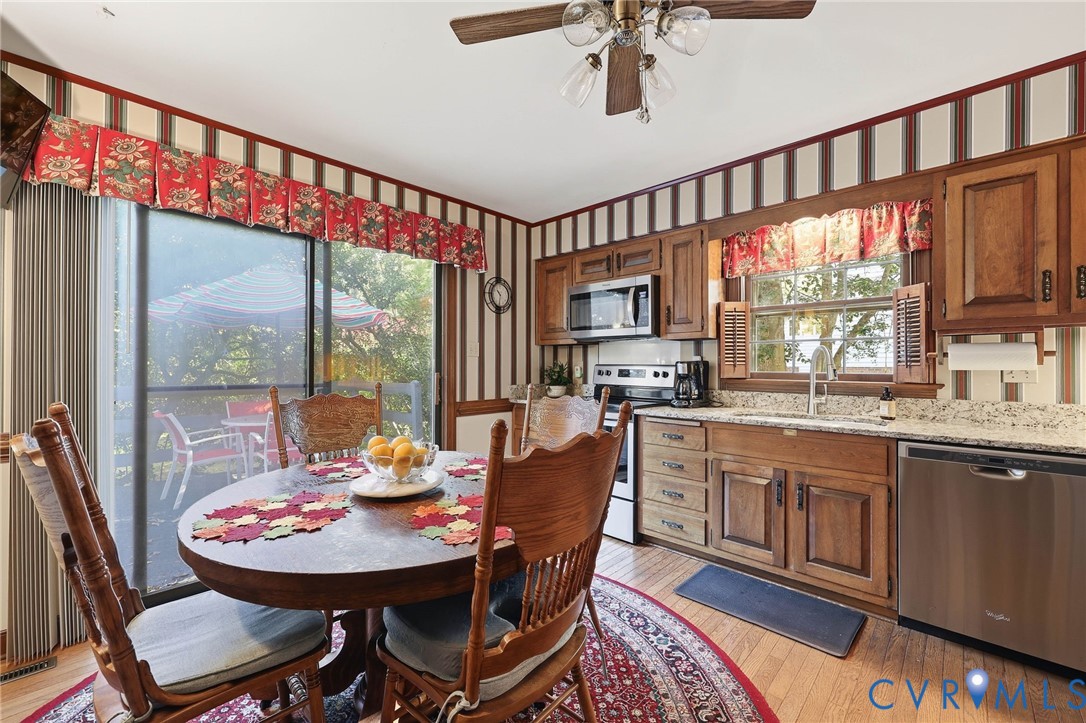 8216 Chainmaile Road North Chesterfield, VA 23235 - Photo 10 of 36 a dining room with furniture a rug a flat screen tv and a large window