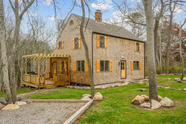 a backyard of a house with table and chairs