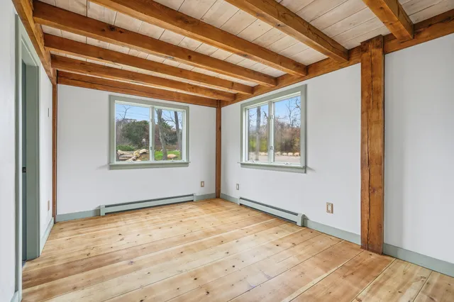 a view of a swimming pool with a table and chairs under an umbrella