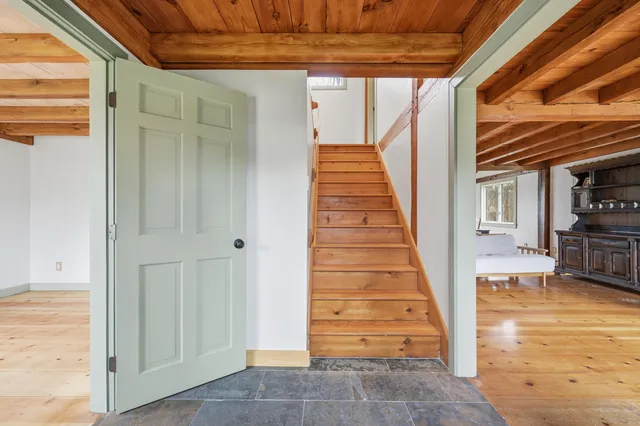 a view of a house with backyard and a tree