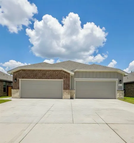 a view of a white house with a yard