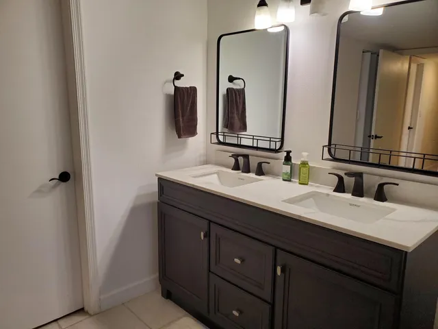 a bathroom with a double vanity sink and a mirror