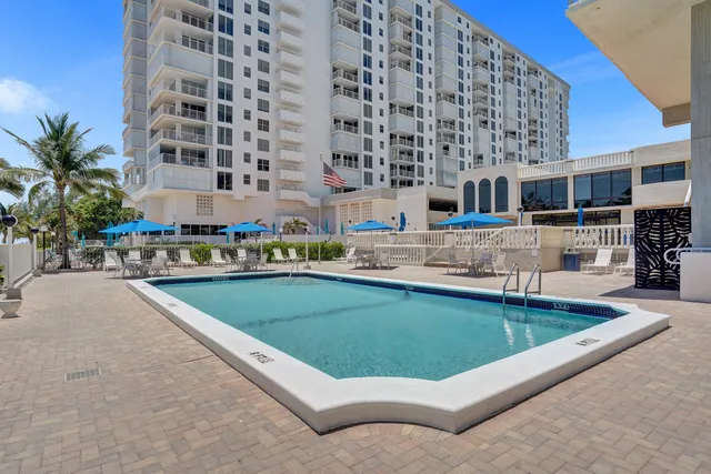 a view of a swimming pool with outdoor seating