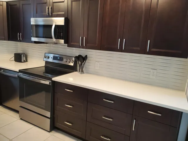 a kitchen with a sink and a stove top oven