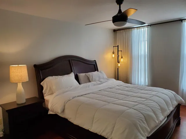 a bedroom with a bed and a night stand