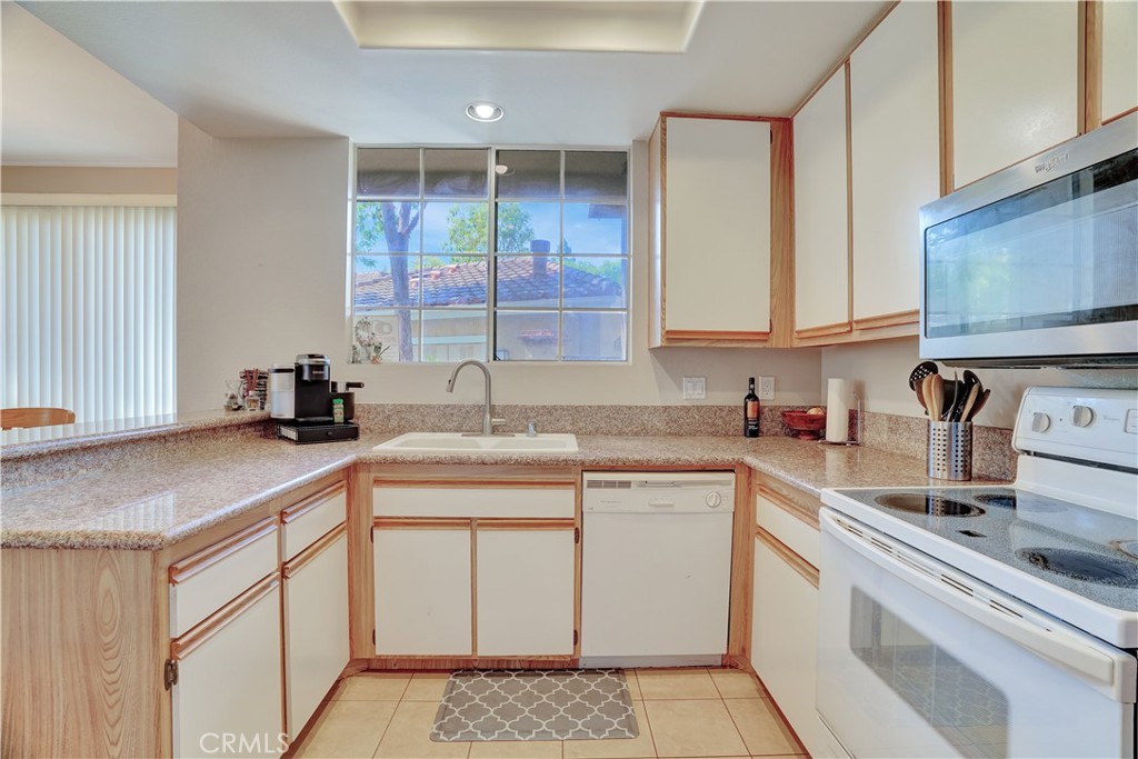 234 Gallery Tustin, CA 92782 - Photo 10 of 46 a kitchen with a sink cabinets and window