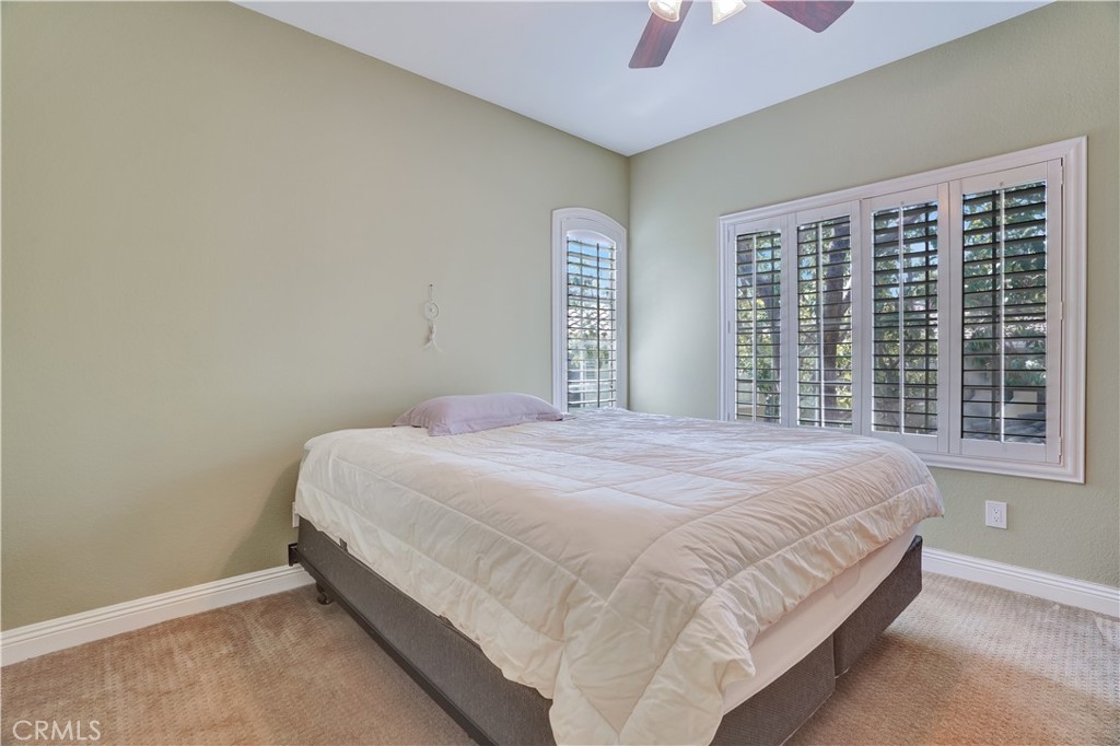 234 Gallery Tustin, CA 92782 - Photo 20 of 46 a bedroom with a bed and a chandelier