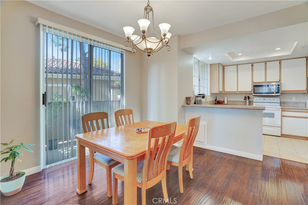 234 Gallery Tustin, CA 92782 - Photo 7 of 46 a dining room filled chandelier and wooden floor
