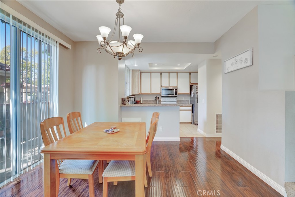 234 Gallery Tustin, CA 92782 - Photo 46 of 46 a view of a dining room with furniture wooden floor and chandelier