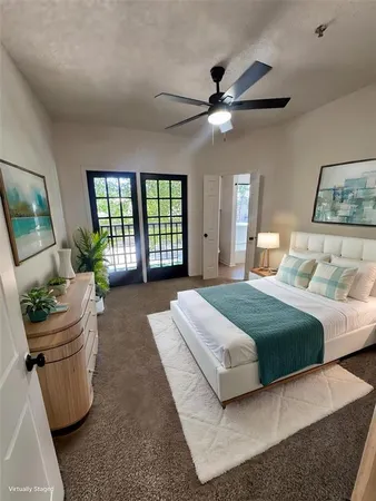 a bedroom with a large bed and a chandelier