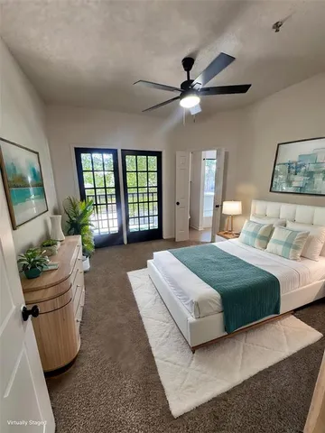 a bedroom with a large bed and a chandelier
