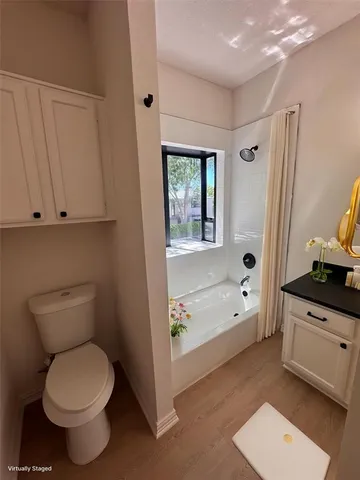 a bathroom with a granite countertop toilet a sink and bathtub