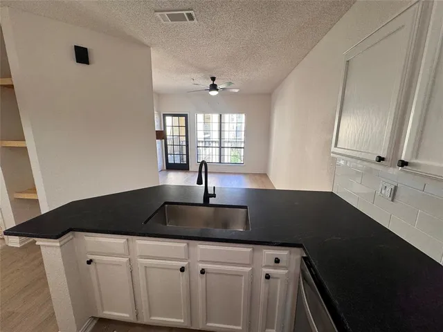 a kitchen with a sink and a window