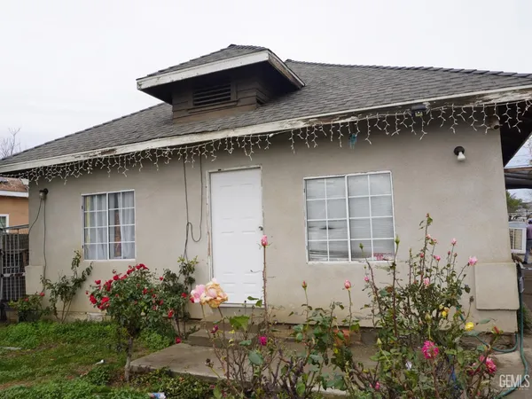 a house with a flower garden in front of it
