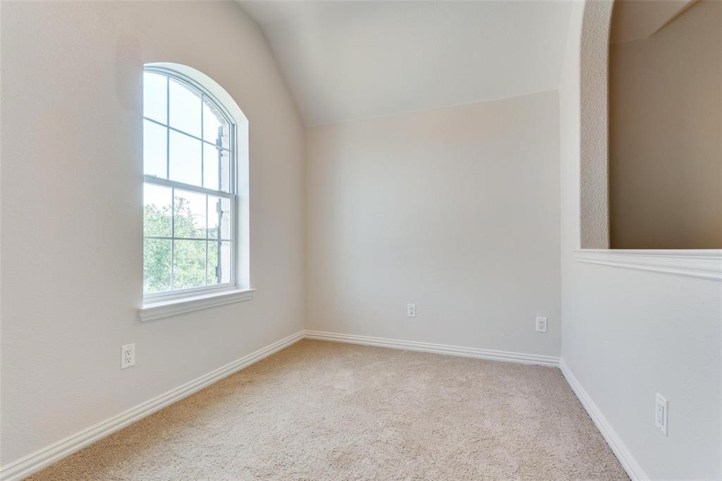 2344 Ranchview Drive Little Elm, TX 75068 - Photo 16 of 24 Room featuring an arched transom window, neutral carpet flooring, white baseboards, and a half-wall architectural detail