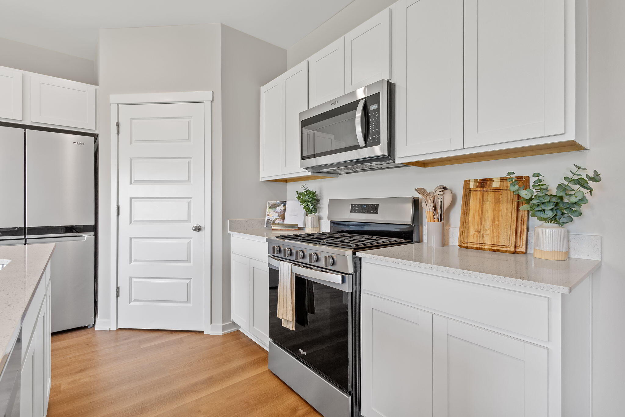 445 Bricker Street Hebron, IN 46341 - Photo 2 of 24 a kitchen with white cabinets and stainless steel appliances