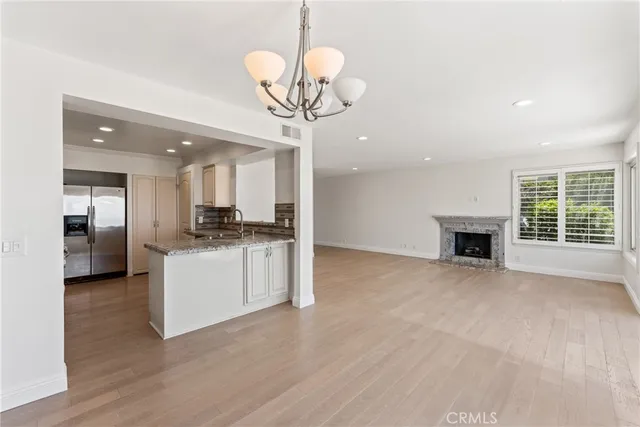 a kitchen with stainless steel appliances granite countertop a sink and a stove