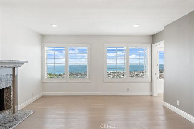 a living room with a fireplace and a window