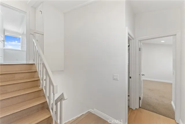 a bathroom with a toilet a sink a mirror and vanity