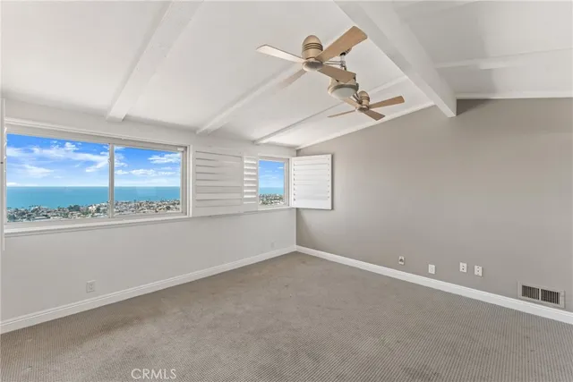 an empty room with a bathroom and a shower