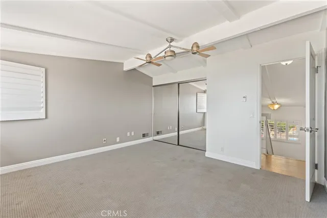 a view of a livingroom with a ceiling fan and window