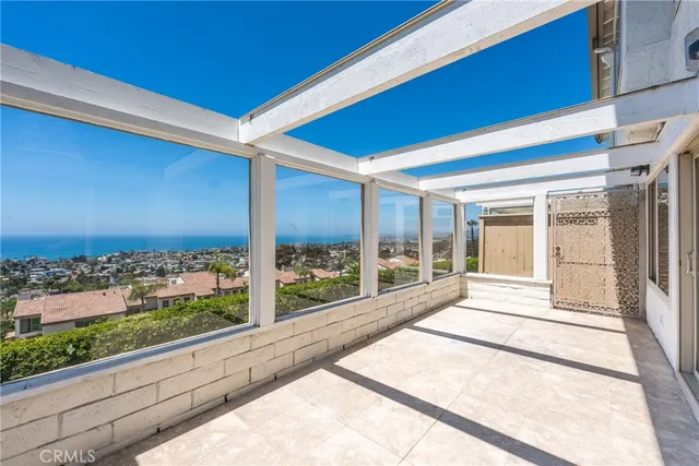 a large white building with glass windows and door