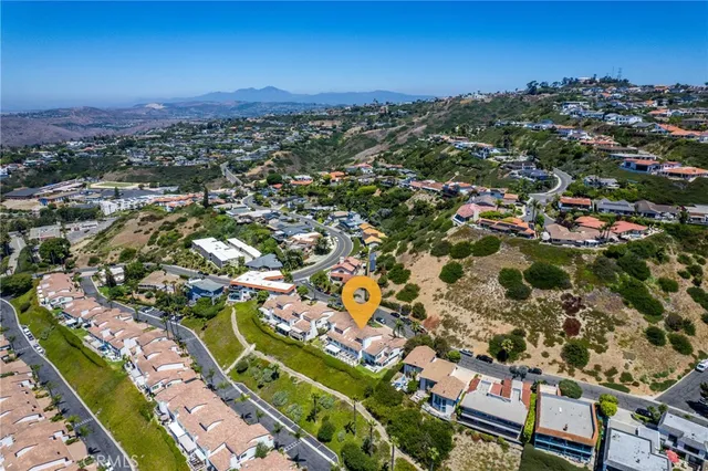 an aerial view of residential houses with outdoor space and river