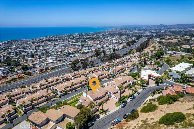 an aerial view of residential building and ocean