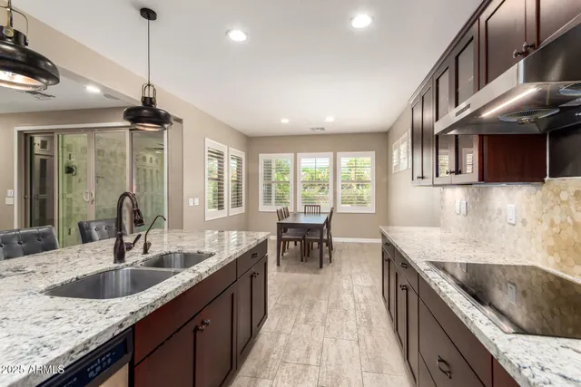 a kitchen with sink stove top oven and cabinets