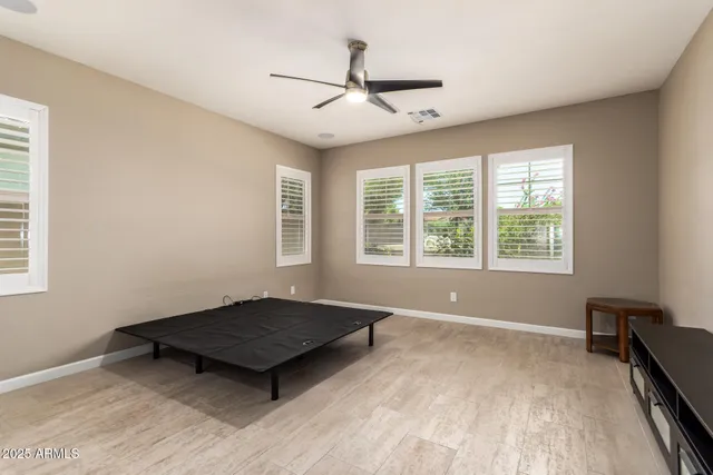 a living room with a bed and a window