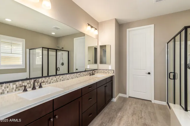 a bathroom with a double vanity sink mirror and double