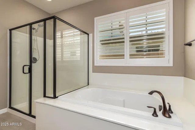 a bathroom with a bathtub and a shower