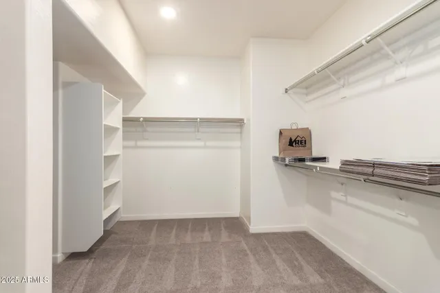 a view of a refrigerator in kitchen and an empty room