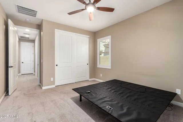 an empty room with windows and closet