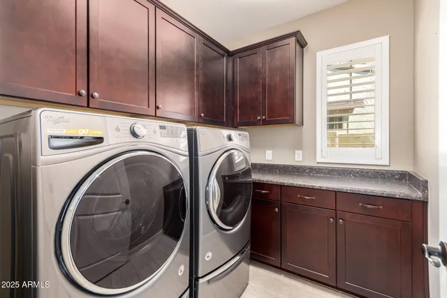 a utility room with sink dryer and washer