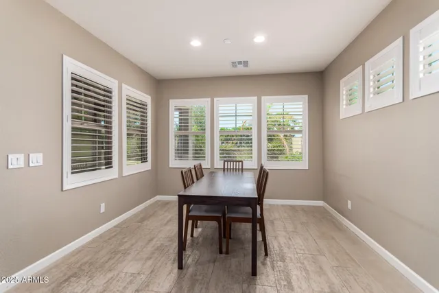 a view of a work space with wooden floor and a window