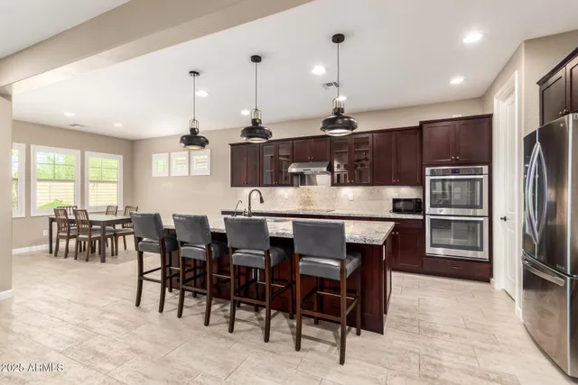 a large kitchen with a table and chairs
