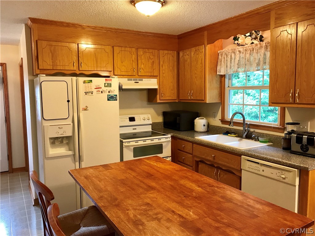 5409 Takach Road Prince George, VA 23875 - Photo 14 of 26 a kitchen with stainless steel appliances a stove a sink and a refrigerator