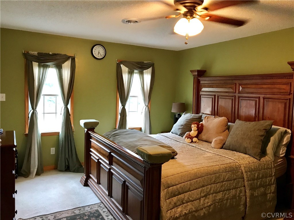 5409 Takach Road Prince George, VA 23875 - Photo 18 of 26 a bedroom with a bed and a chandelier