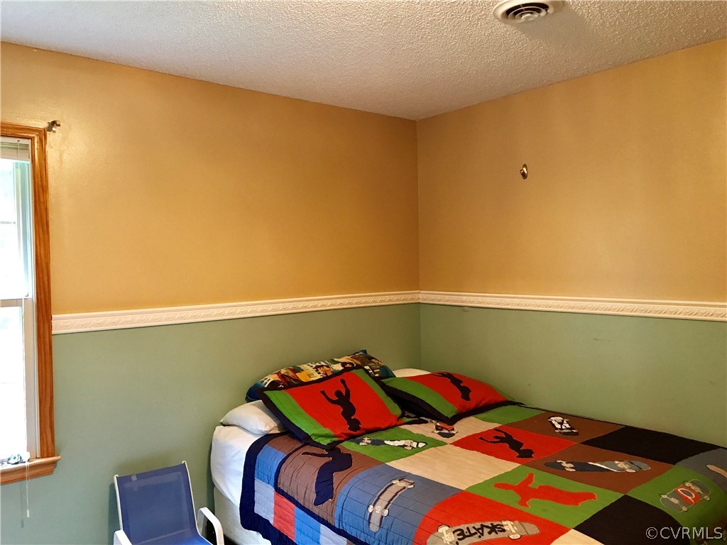 5409 Takach Road Prince George, VA 23875 - Photo 22 of 26 a bedroom with a bed and cabinets