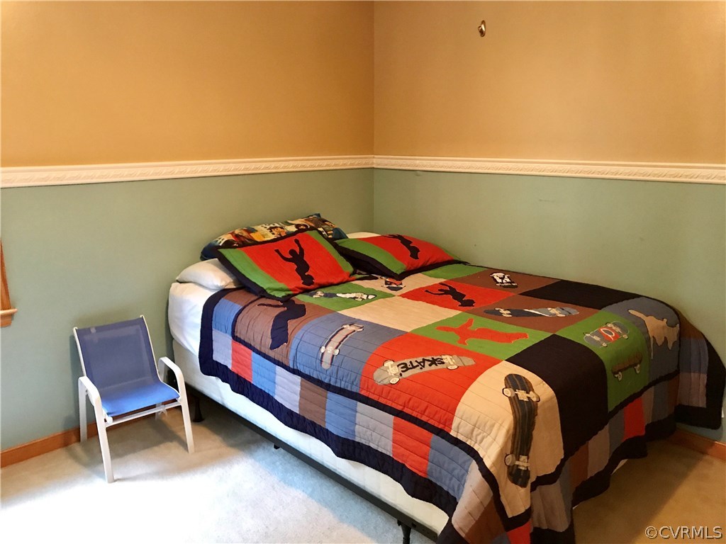 5409 Takach Road Prince George, VA 23875 - Photo 23 of 26 a bedroom with a bed chair and table