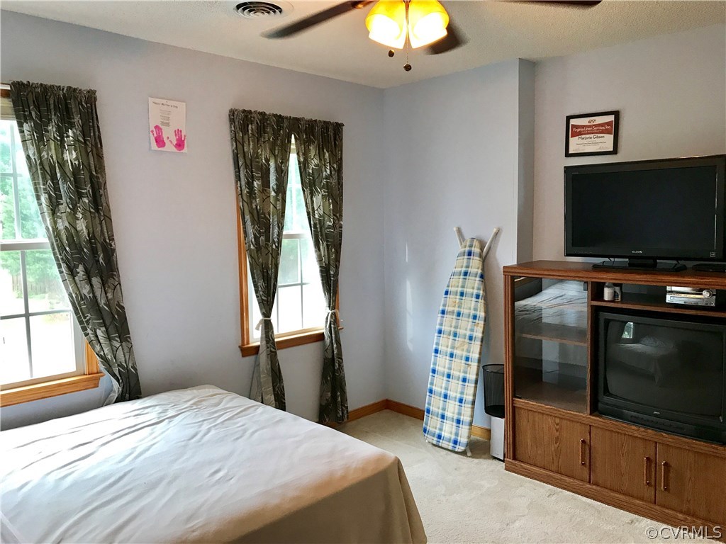 5409 Takach Road Prince George, VA 23875 - Photo 25 of 26 a bedroom with a bed and a flat screen tv