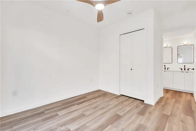 a bathroom with a double vanity sink mirror and toilet